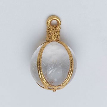 An exquisite and rare pendant of 5th-7th century date. It is made from a large polished rock crystal sphere with very few flaws. The crystal is encased within an ornately decorated  openwork gold frame like cage. It is most likely of continental Frankish workmanship.