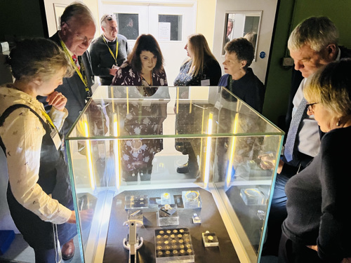 People viewing the hoard in a display case at MRLC